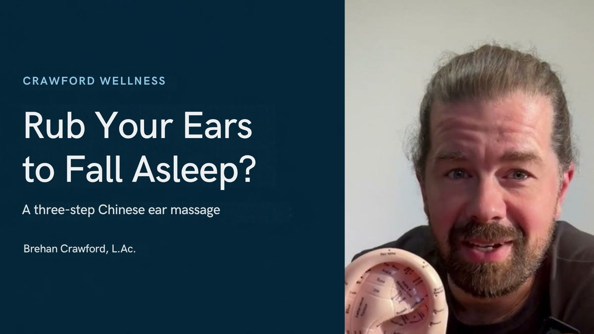 Does rubbing your ears make you sleepy? Brehan Crawford, L.Ac., holding an ear model marked with acupuncture points